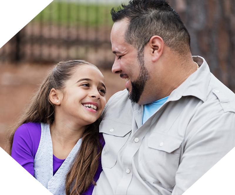 father smiling at his daughter